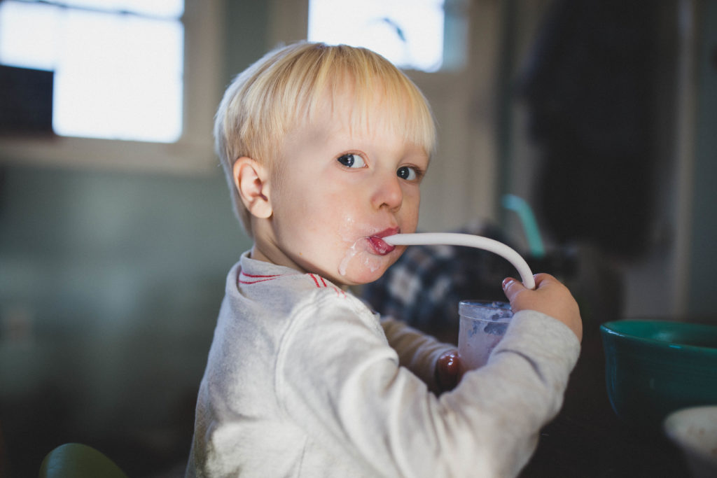  little boy drinking healthy organic smoothie