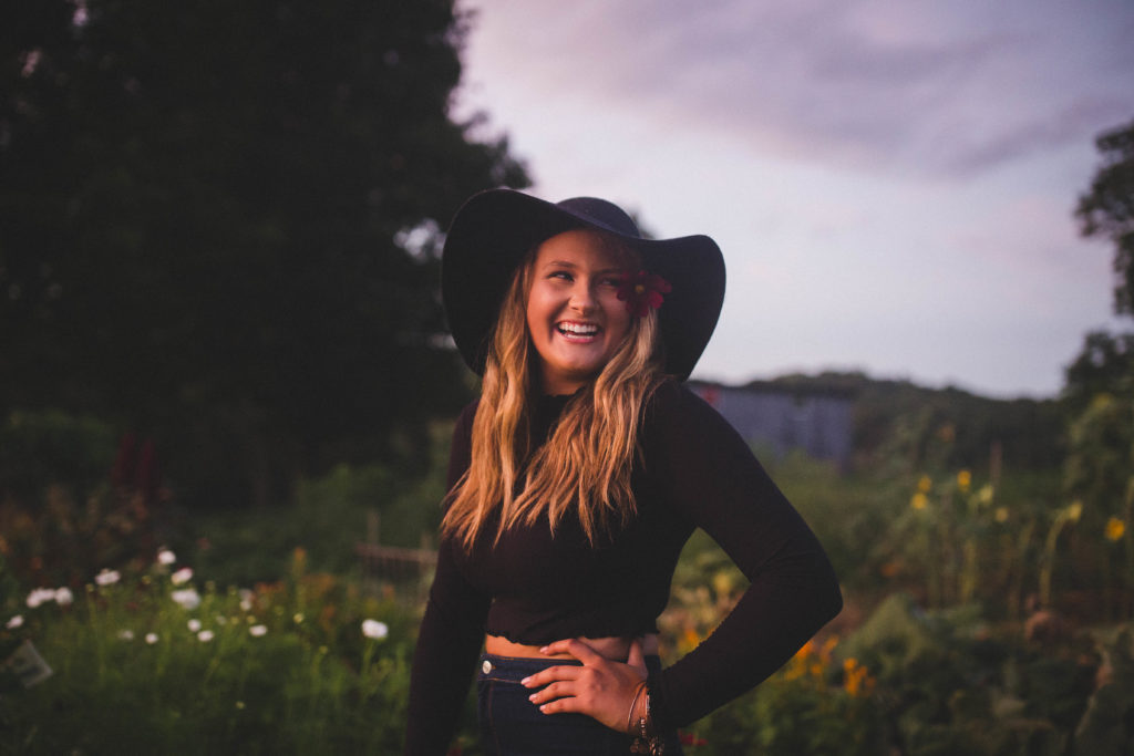 teenage girl in a flower farm smiling 
